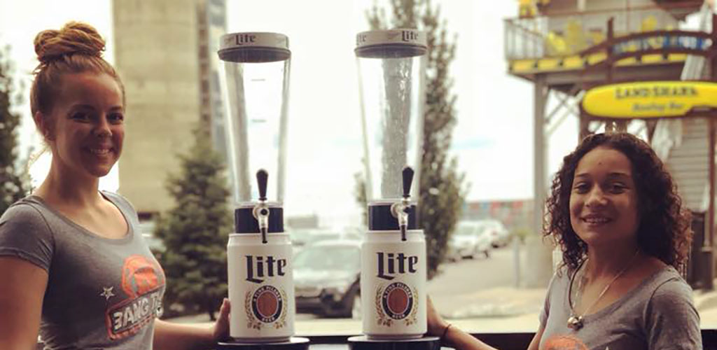 Two pretty servcers at Big Bang carrying cool Miller Lite draft pints