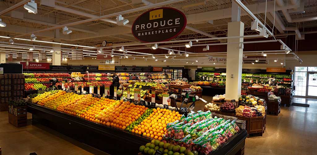 Heinen’s Grocery produce section with a row of various citrus fruits in front