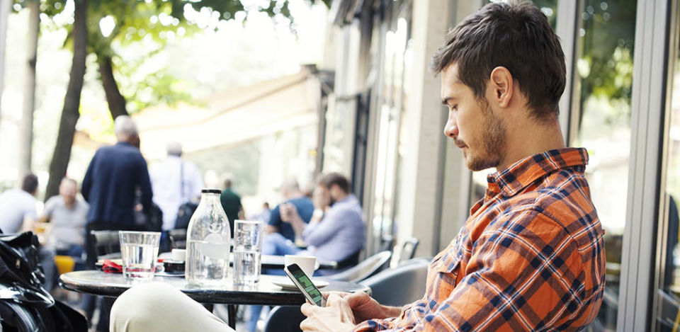 Man in a cafe learning how to respond to an ex asking how you are