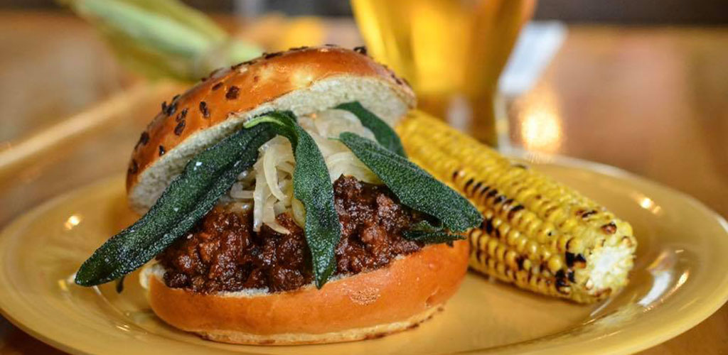 A burger and roasted corn from Beachwood BBQ