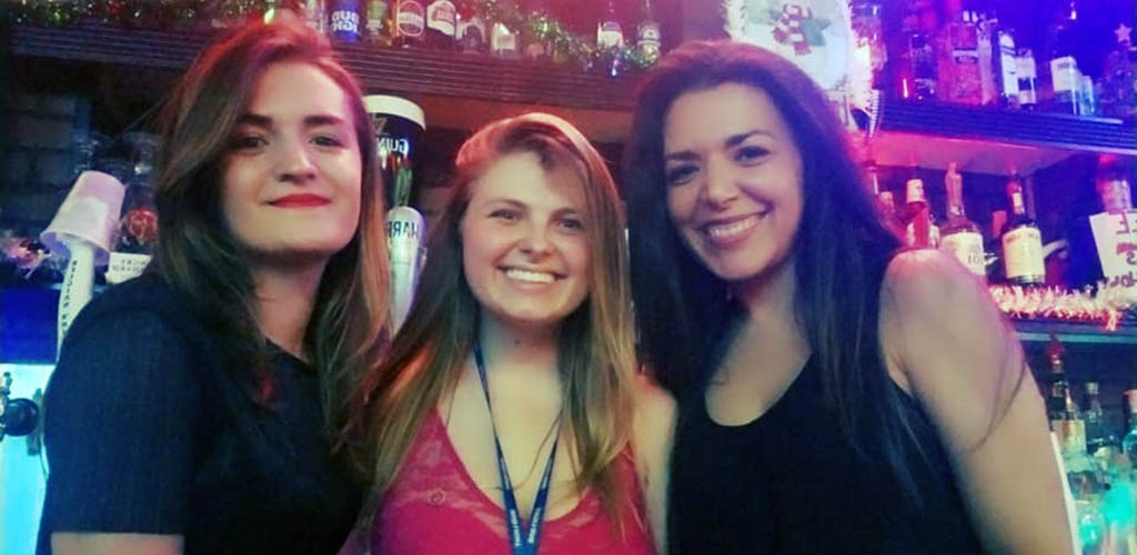 3 beautiful young ladies smiling at the bar in Murphy's Pub and Lounge