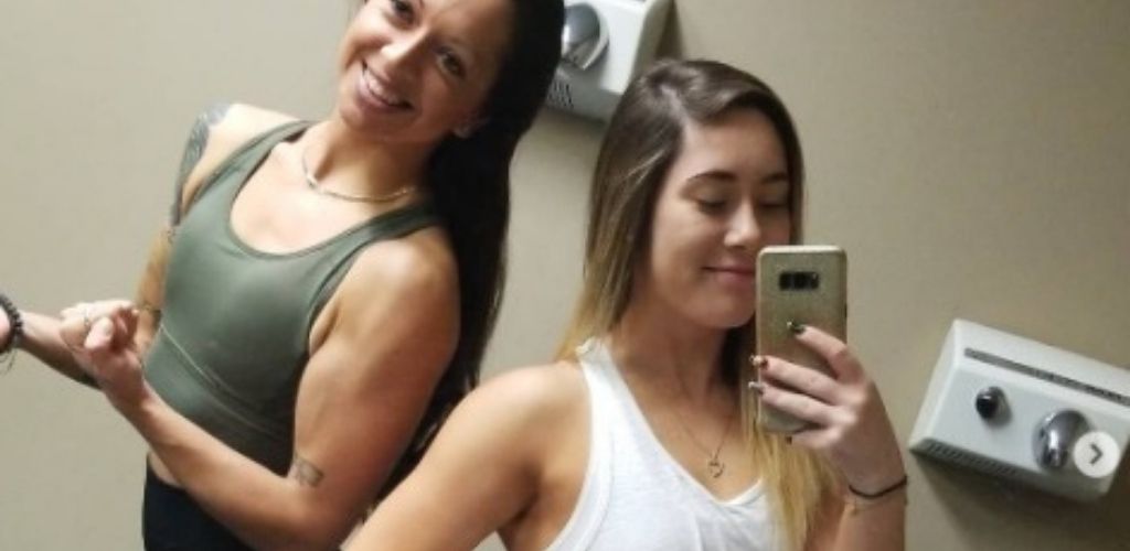 Cute Longueuil singles taking a mirror selfie at World Fitness