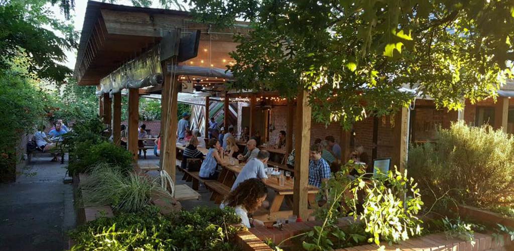 People mingling over beer and comfort food at Geer Street Garden in Durham