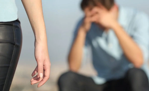 woman walking away from man wondering how to get over cheating