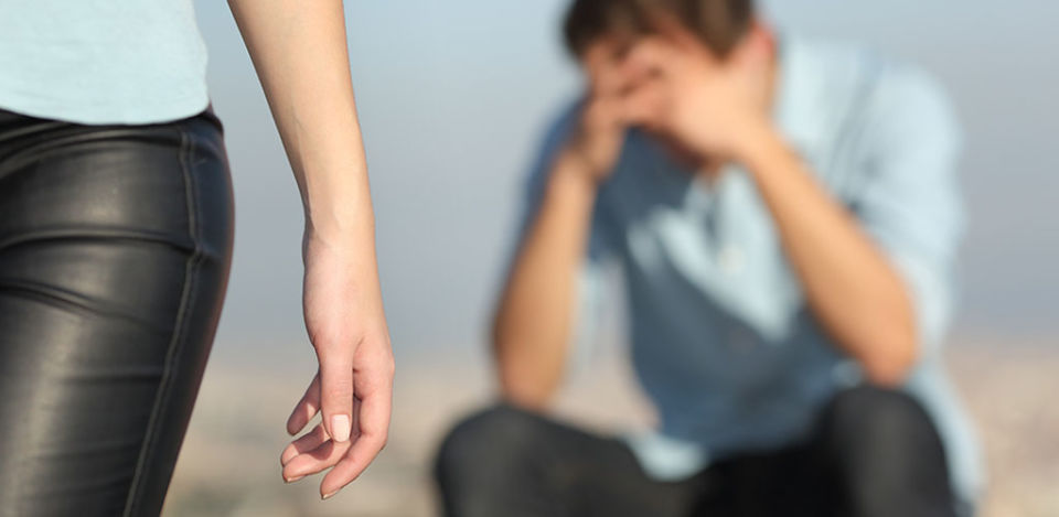 woman walking away from man wondering how to get over cheating