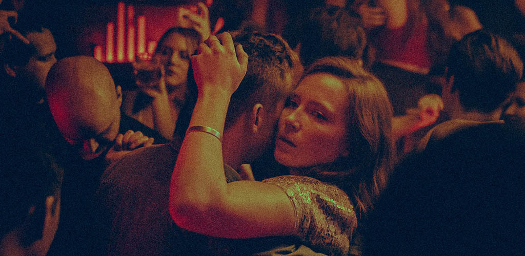 A couple getting cozy on the dance floor of Rouge Bar