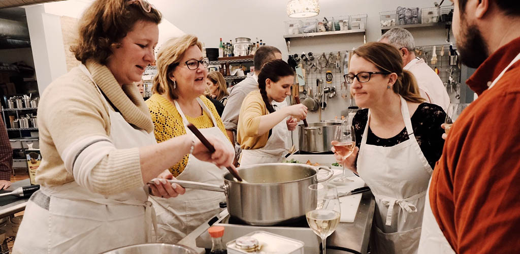 Women in a cooking class at Schola