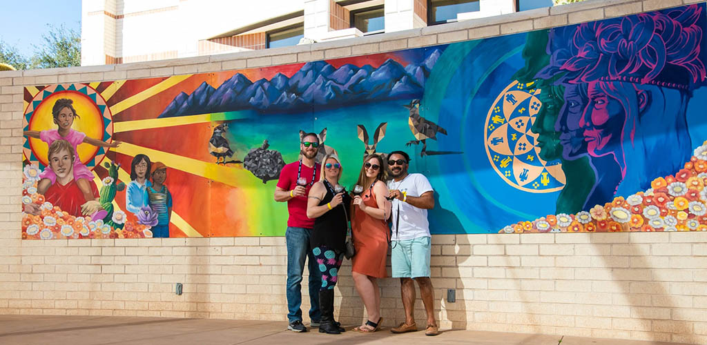 Posing in front of the mural at the Arts and Crafts Studio