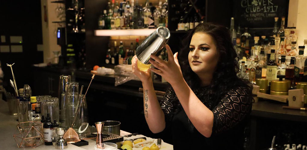 A gorgeous woman mixing drinks at Society Lounge