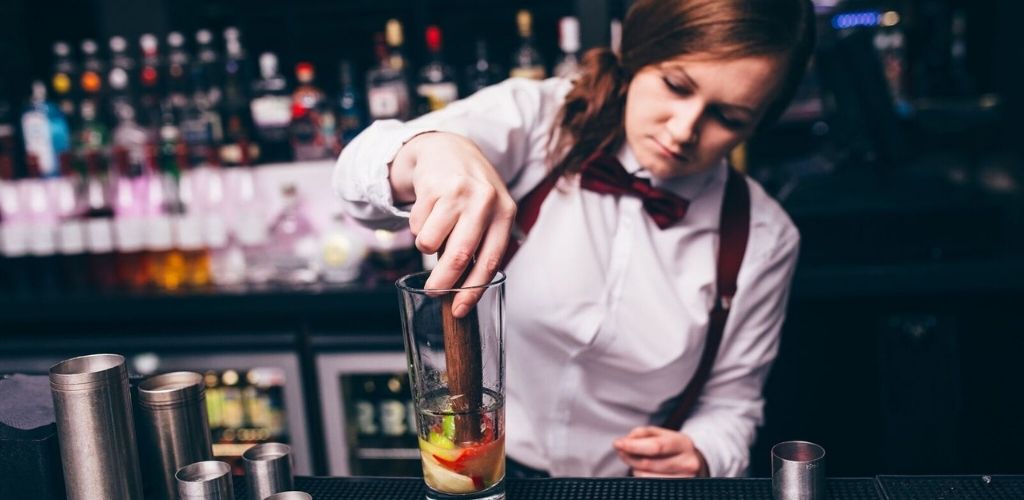 A cute Glasgow bartender mixing cocktails in 