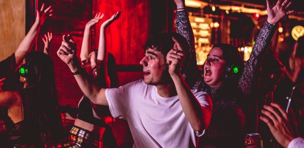 A crowd of young singles enjoying beer and music at Thekla boat club in Bristol