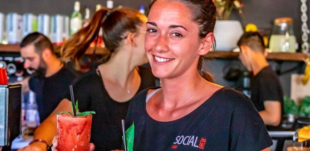 A cute barista serving smoothies at Social Brew Cafe in Sydney