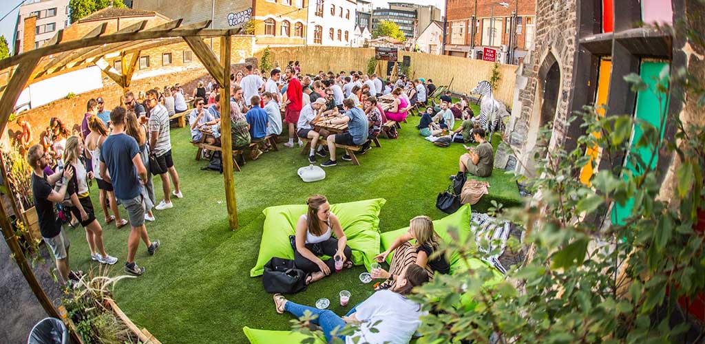 The sunny outdoor area of Stokes Croft Beer Garden where you can find Bristol hookups