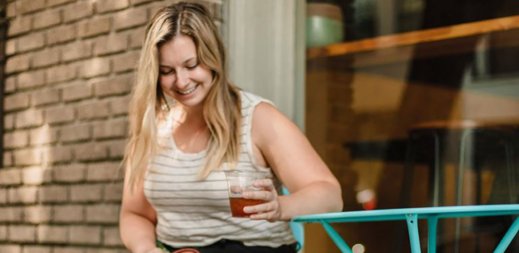 A curvy woman with iced coffee from Mammoth Espresso