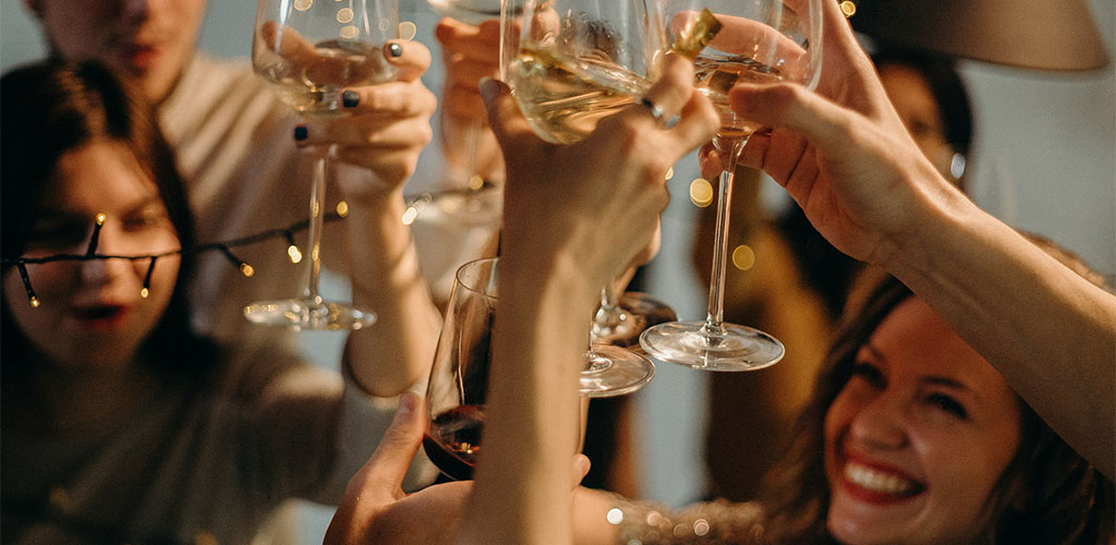 Group of people toasting at a house party