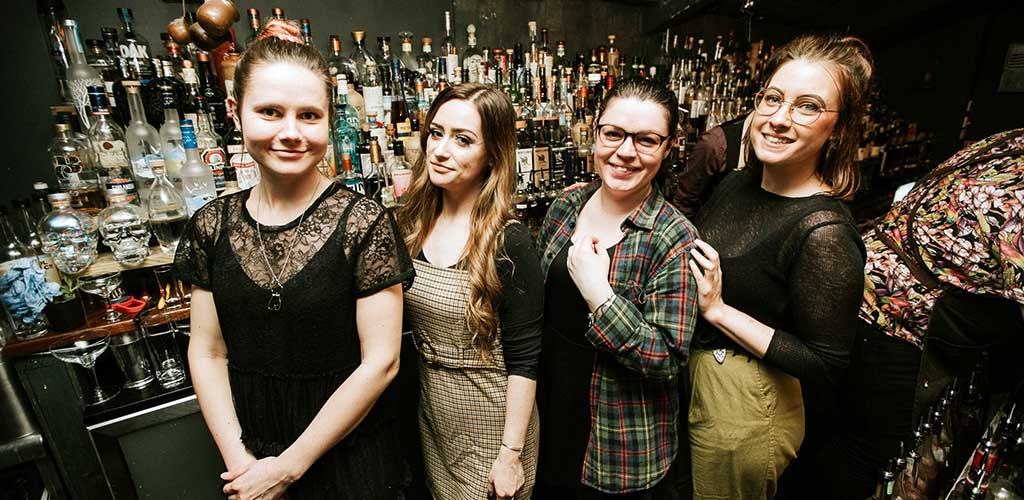 Cute Cardiff singles posing in front of the bar at The Dead Canary