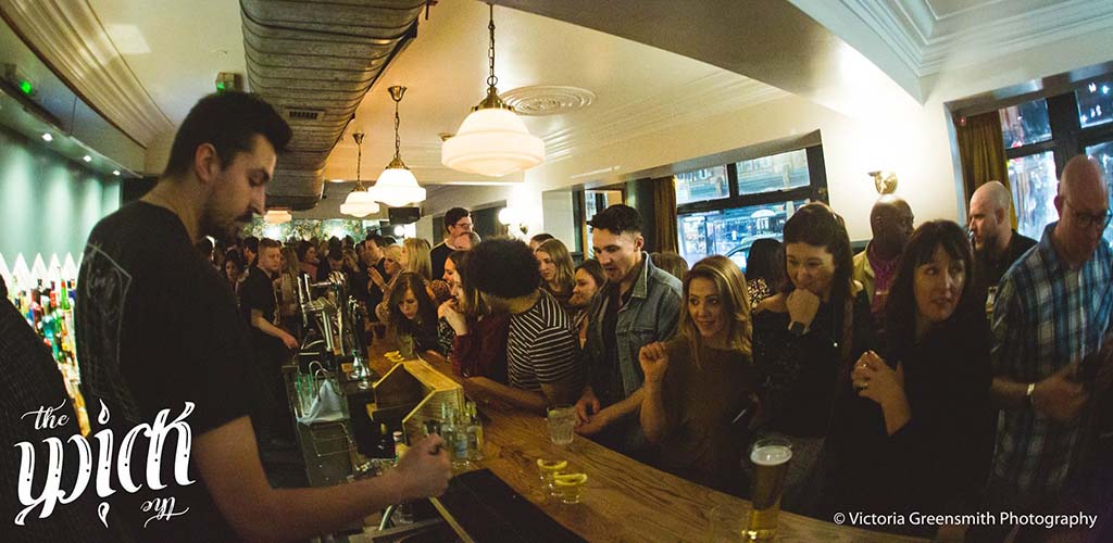 Young Sheffield singles waiting for drinks in a bar on West Street 