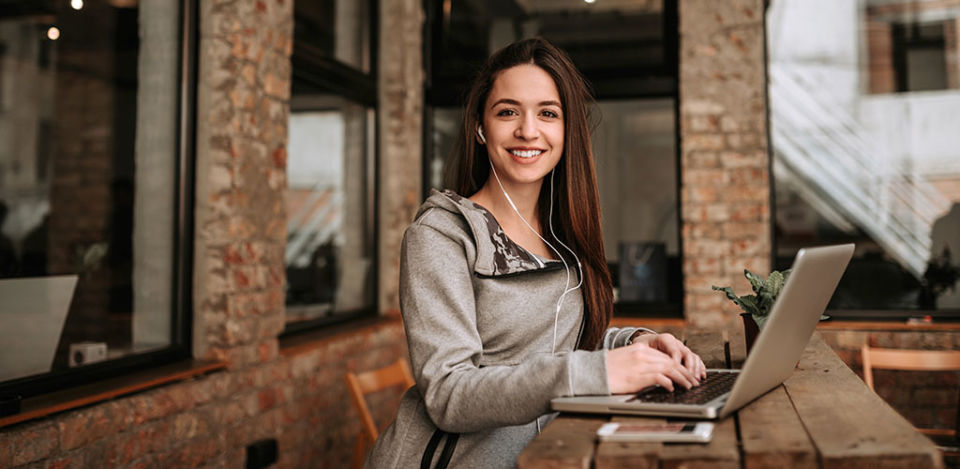 Single woman seeking men in Stoke-on-Trent working on her laptop at a cafe