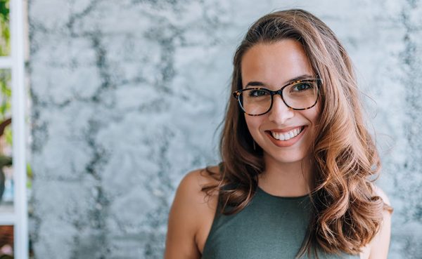 New York girl in glasses smiling