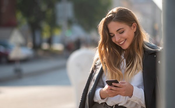 Single woman seeking men in Leicester texting while smiling