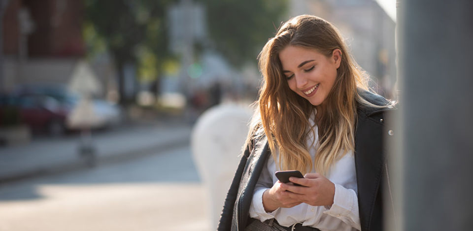 Single woman seeking men in Leicester texting while smiling