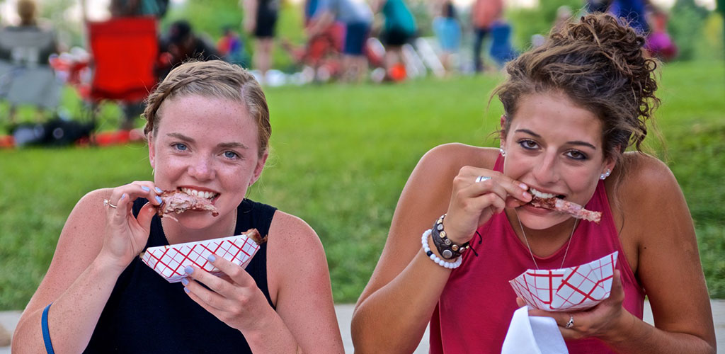 Cute girls enjoying ribs at The Jazz & Rib Fest