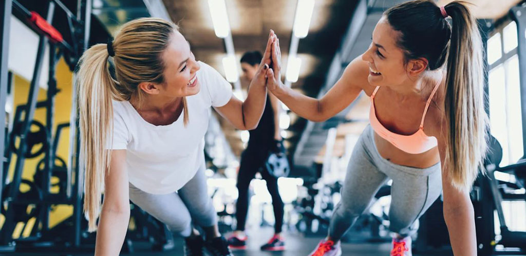 Two beautiful girls working out at Capital Athletic Club