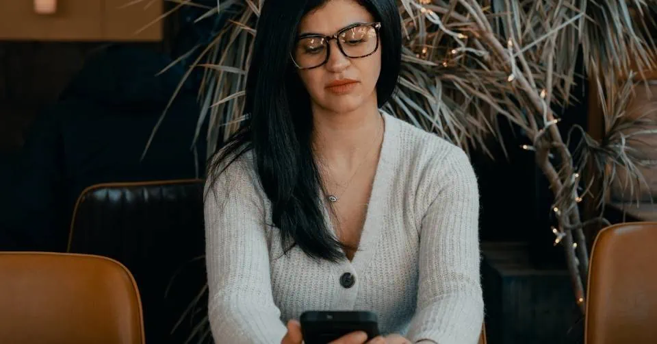 Skeptical woman using Tinder