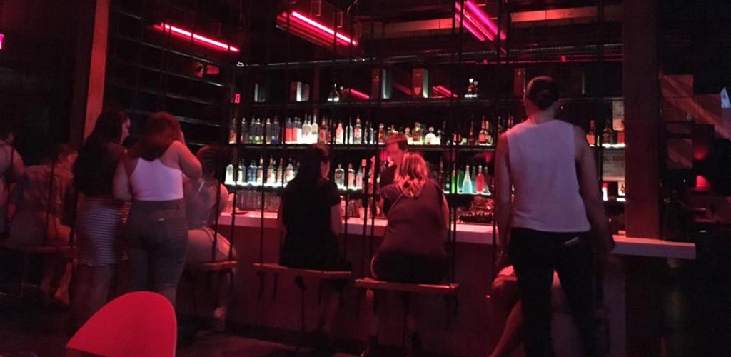 The bar at Mingle Lounge where the barstools are swings