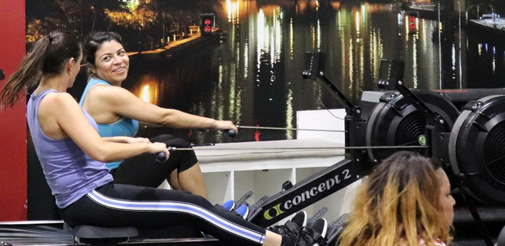 Two ladies on the rowing machine at Ferrino Sports