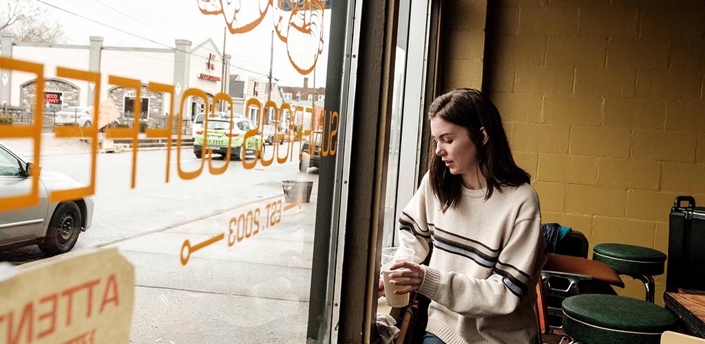 A girl by the window of Sunegros Coffee