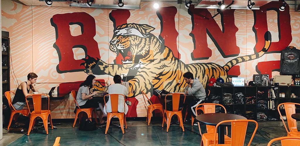 The Blind Tiger mural with a few patrons