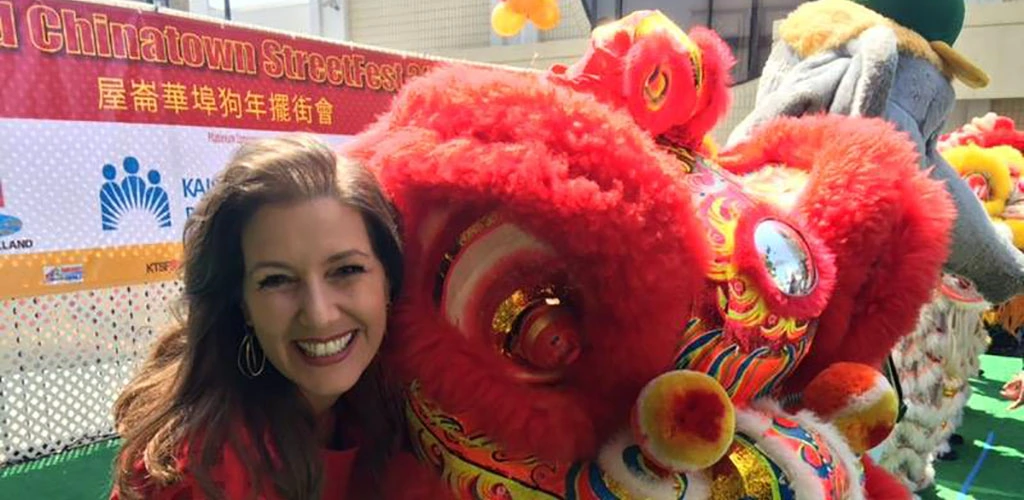 Posing beside the dragon figure at the Oakland Chinatown Street Festival