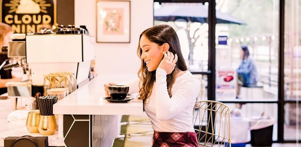 A hot girl drinking a latte at Cloud 9 Coffee