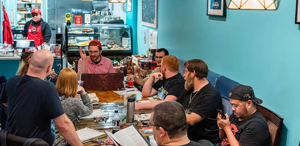 Friends enjoying board games at Dice and Beans