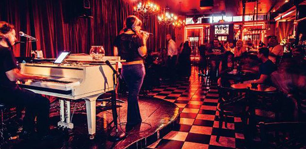 The evening crowd during a piano performance at Don't Tell Mama