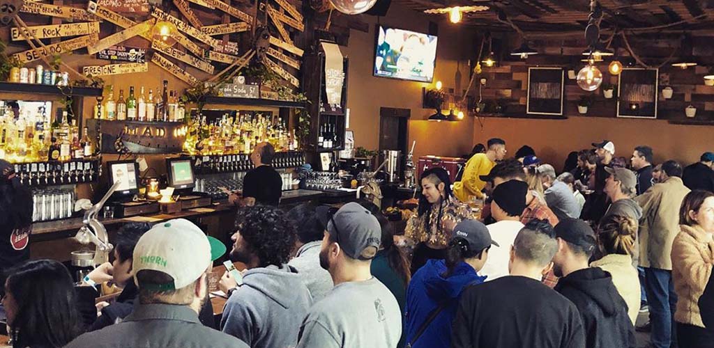 People crowding around the bar at Mad Oak