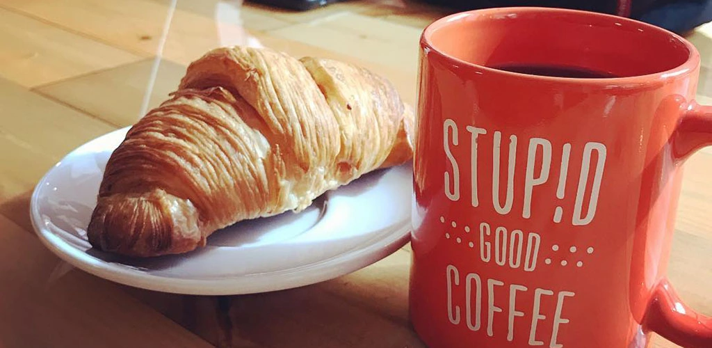 A croissant and coffee from Stupid Good Coffee