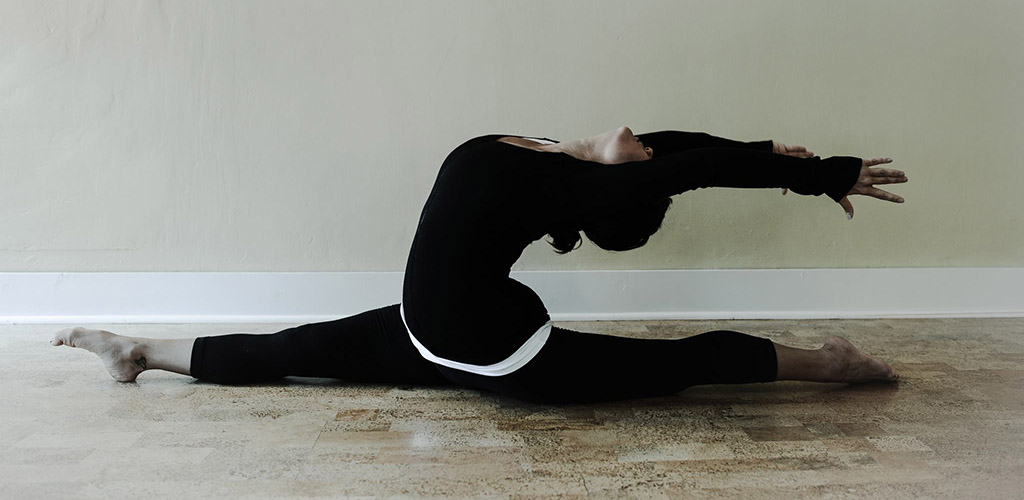 Practicing a challenging yoga pose at Yoga on Baxter