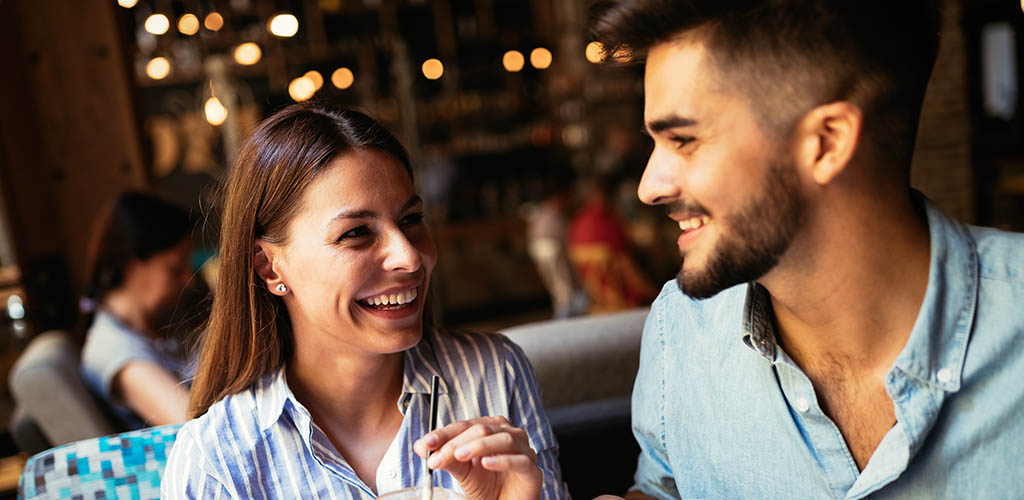 A young man flirting with his crush at a coffee shop