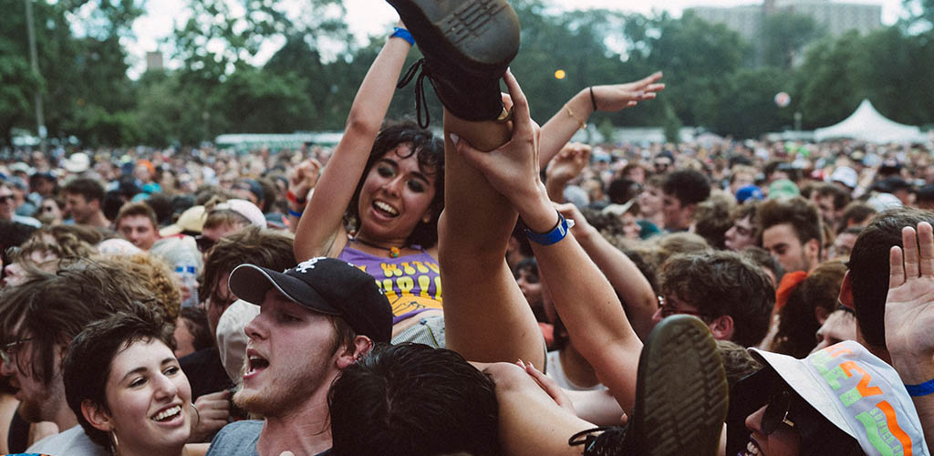 A girl being hoisted up by the audience at Pitchfork Music Festival