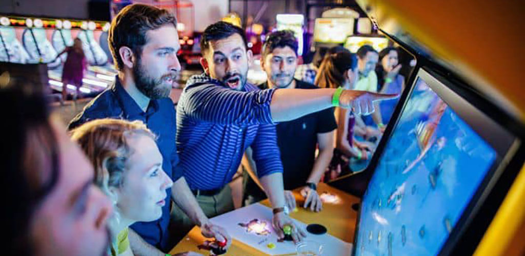 Friends playing the arcade at Bishop Ciderade