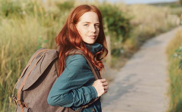 A pretty redhead girl on a hike