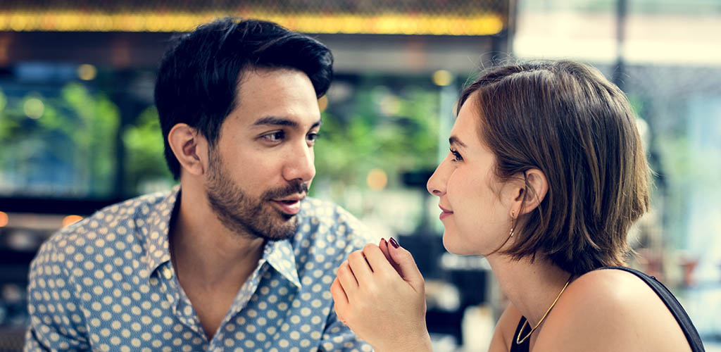 A man talking to his crush at a cafe