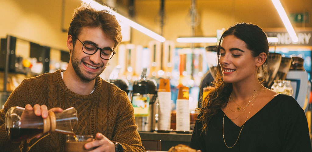 A couple drinking coffee on a date at Coffee Island in London