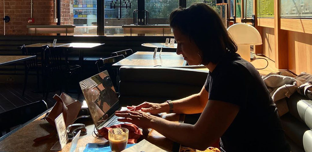 Working on her laptop at Ducie Street