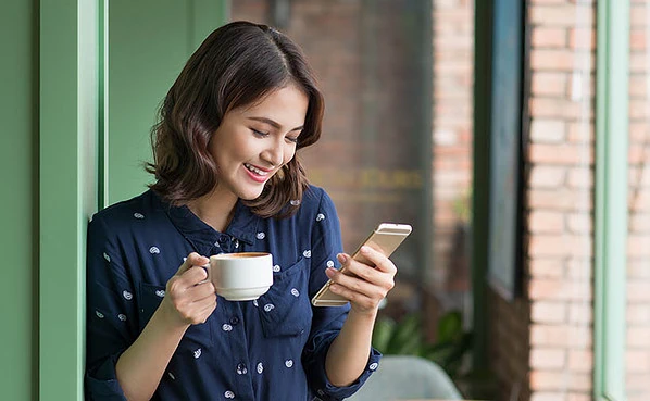 Checking out the best Pittsburgh dating apps during her coffee break