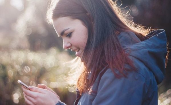 Woman using a dating app on her phone