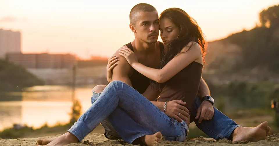 Couple in jeans on the beach