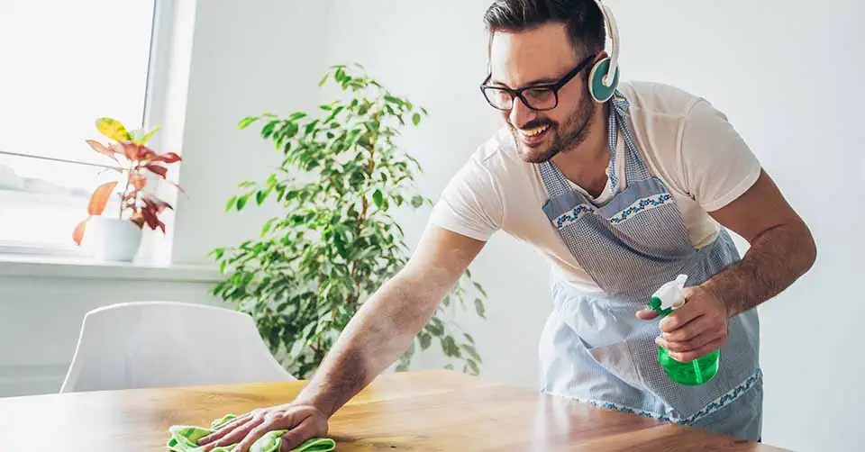 A man listening to some music while doing chores